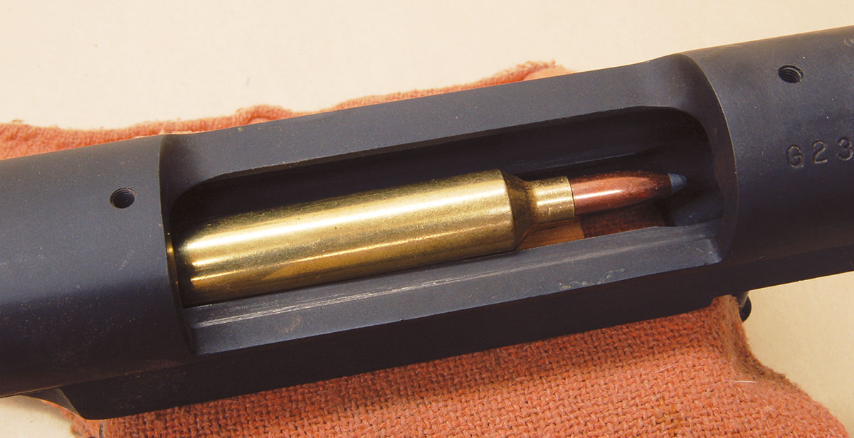 A 26 Nosler cartridge completely fills the magazine area of this 30-06 length M70 action.